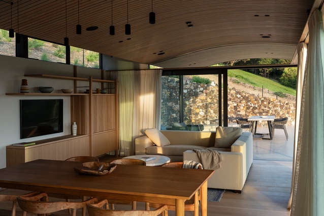 The up-kick to the ceiling allows the spaces to open up to the south through high-level bands of window.