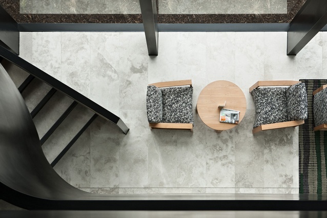 A bird's eye view of casual seating adjacent the stair.