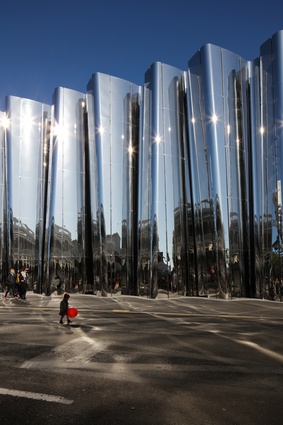 "A repetitive koru design is sinuously carved in concrete and explodes upwards towards the sky," creating a "draped curtain of architecture, people and sky in constant motion"