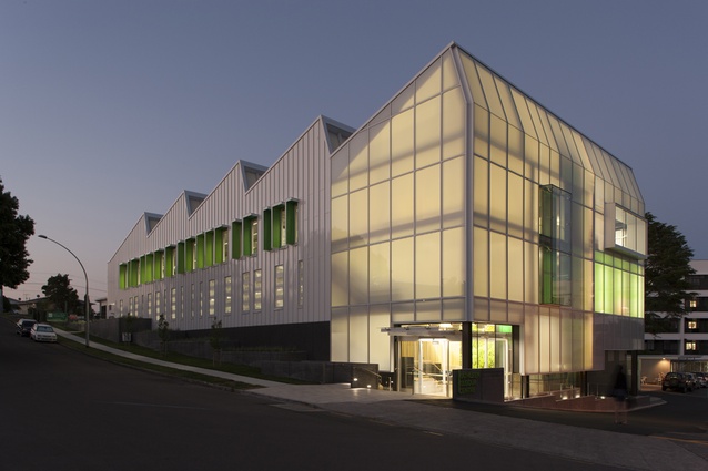 Wingate+Farquhar's Kathleen Kilgour Centre acts like a light box at night, emanating a soft green-and-white glow within the Tauranga Hospital Campus. 