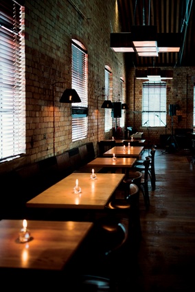 Bespoke lamps and furniture maintain a connection to the original Wellington restaurant and the heritage building. 