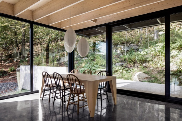 The Rock, Quebec, Canada, by Atelier General. 2017. Floor-to-ceiling glazing wraps around the dining area and provides a connection with nature.