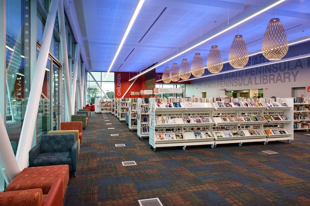 Spaces within the library are created by screens and furniture.