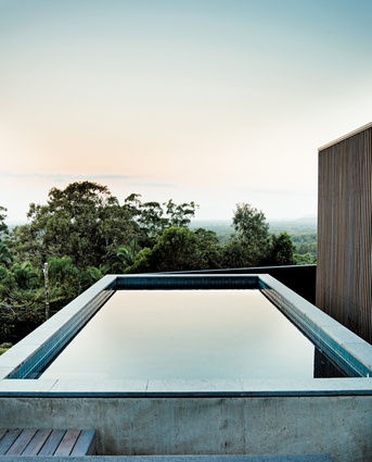 An off-form concrete pool offers elevated views over the eucalyptus forest to the south.