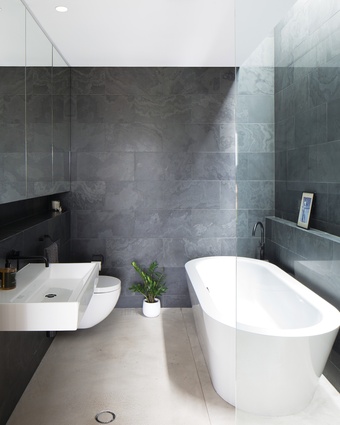 Featuring Brazilian slate wall tiles, the ensuite is a compact yet beautiful space in which to unwind.
