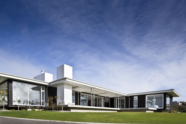 Deep overhangs, ample glazing and an achromatic colour scheme stamp the Pauatahanui House with a modernist aesthetic. 