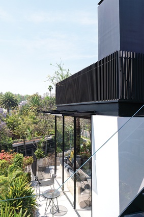 The home doesn’t have a garden, so the architects introduced a triangular concrete canopy, a rooftop terrace and a generously sized patio at the rear of the residence to afford it some outdoor space
