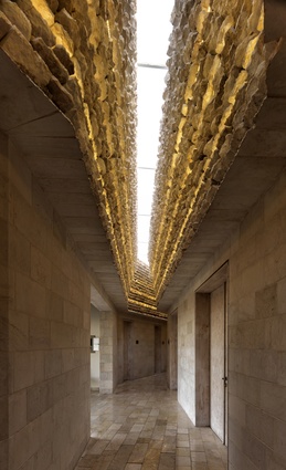 Royal Academy for Nature Conservation, Ajloun, Jordan. A crack in the ceiling of the corridors creates a contrast of light and shadow on the interior limestone cladding.