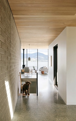 Upon entering the home, the curving southern wall and long arc in the roof pane draw you inside and towards the view.