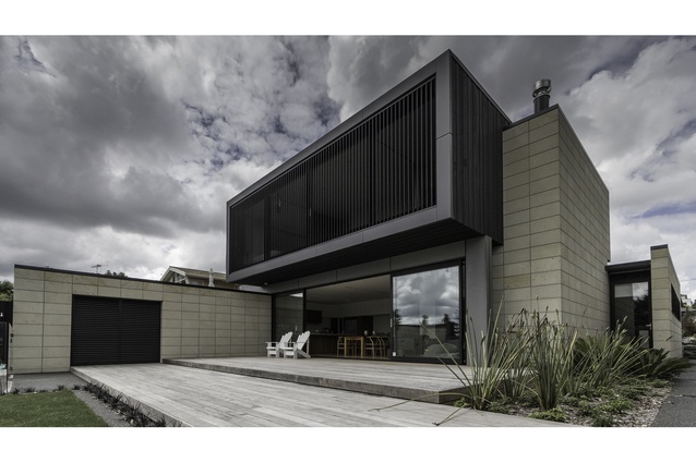 Arran Road residence. Darkly stained cedar boards are offset by the soft Hinuera stone.