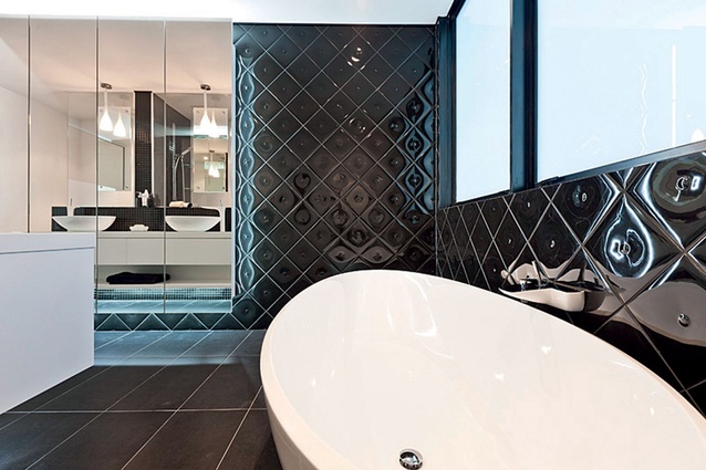 Quilted black tiles around the freestanding bath enhance the luxurious nature of this ensuite.