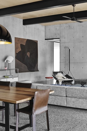 In the living areas, the concrete walls and floor are the perfect backdrop for a range of leather-upholstered seating and the Flack-designed custom-timber dining table. 