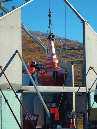 One of the whisky stills being lowered into place. The distillery complex taking shape.