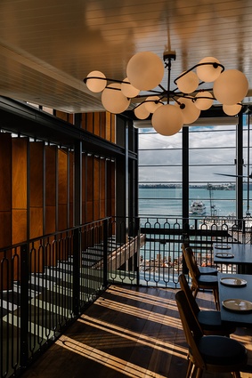 There is a subtle nod to Auckland's boating culture, reflected in high-gloss, white wood plank mezzanine, which is slightly reminiscent of maritime vessel design.