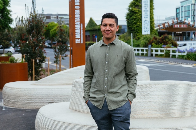 Te Kaunihera o Tāmaki, He Maunga, He Tangata intern Kahurangi Eruera, in front of the Te Maharatanga o Ngā Wai tactical urbanism initiative project. 