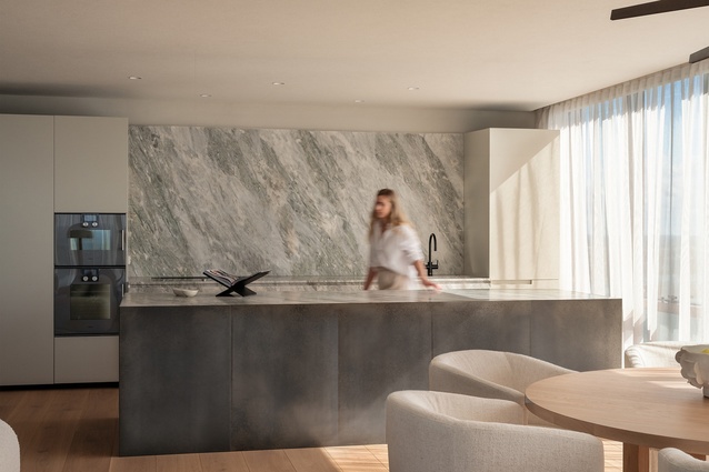 Morning sun casts a soft glow on the subtle pastel tones of the zinc-clad island bench and the quartzite stone splashback.