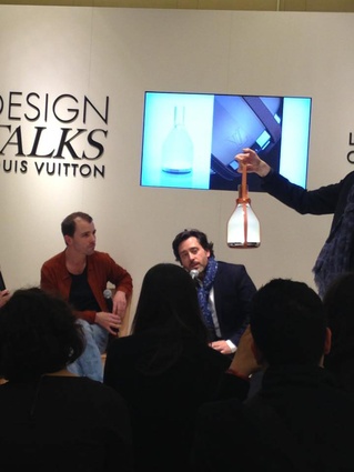 Designer talks at the Louis Vuitton boutique.