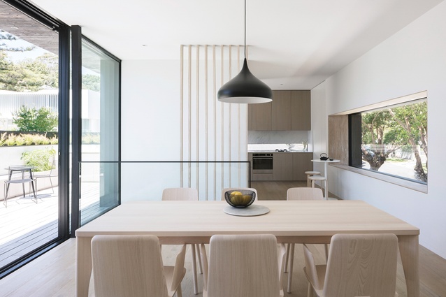 The living spaces feature a pared-back palette of European oak flooring, blackbutt window reveals and clean white walls.