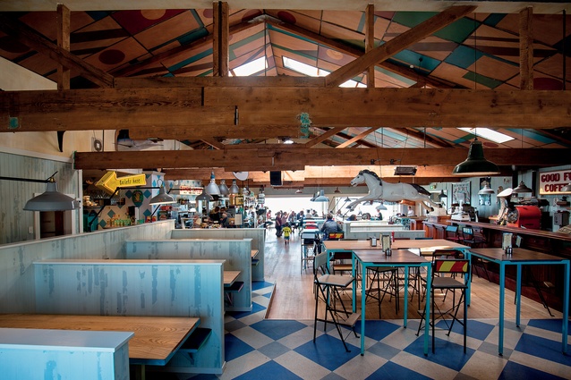 A large warehouse-like space above Petone Rowing Club is now a busy, visually engaging café. Floorboards have been reused as wall cladding.

