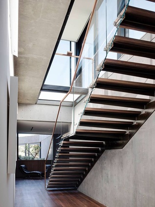 Open risers and glass balustrading feature on the main staircase. 