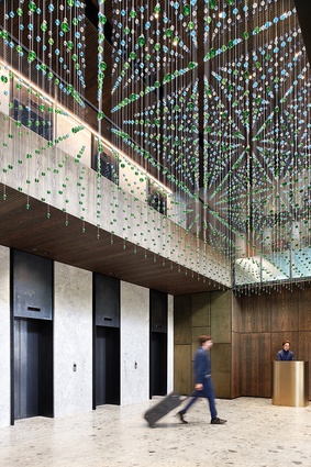 The entrance lobby features an artwork by Nike Savvas above.