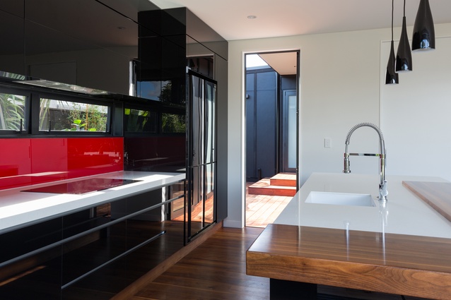 The Mondrian motif is continued throughout the interior through the splash of red in the kitchen splashback.