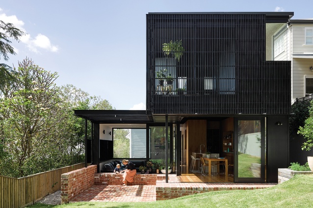 Paddington Residence, Brisbane, Australia, by Kieron Gait Architects. 2017. An addition to a four-bedroom cottage. The upper floor is clad in a black vertical timber veil.