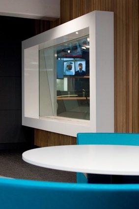 Glass-walled studios offer direct views to news delivering monitors around the rest of the hub.