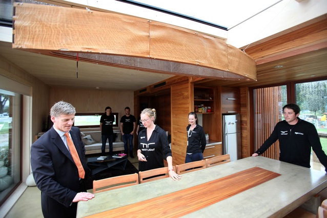The Hon. Bill English, left, Deputy Prime Minister and Minister of Finance of New Zealand spoke with collegiate participants, from left to right, Ben Jagersma, Eli Nuttall, Anna Farrow, Lizzie Earl and Nick Officer while he toured New Zealand's entry in the U.S. Department of Energy Solar Decathlon 2011 in Washington, D.C., Friday, Sept. 23, 2011. 