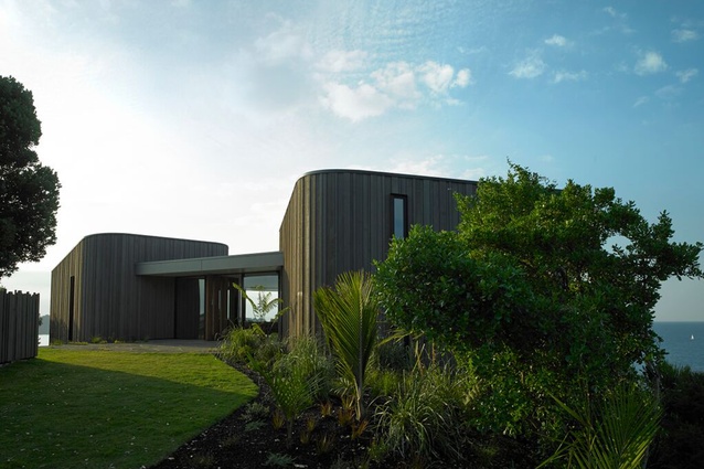 Multi-award winning Headland House, Waiheke Island. This informal, beachy house comprises three timber-clad pod forms and stays sensitive to its landscape.
