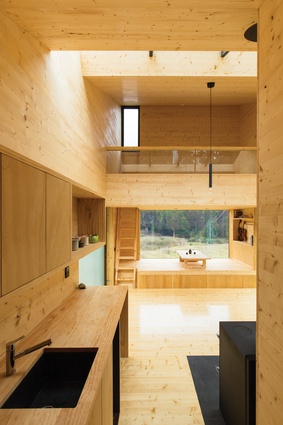 From the entry point, there is an inviting view to the light, honeyed timbers of the cocoon-like interior.