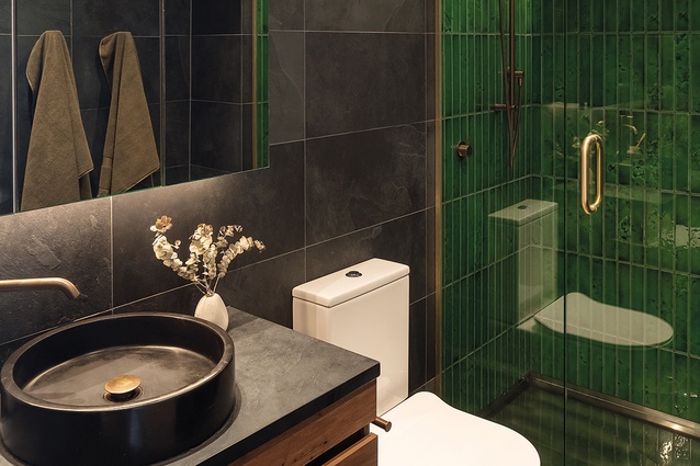 Green tiles bring the vibrancy of the exterior brickwork cladding into the wet areas.