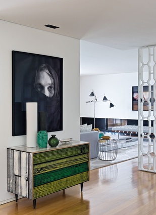 Drawers by <a href="http://www.simonjamesdesign.com/brands/established-sons/125/wrongwoods-low-cabinet/" target="_blank"><u>Established & Sons</u></a> offer a pop of colour in the entrance and contrast with a black-and-white photograph by Graça Sarsfield.
