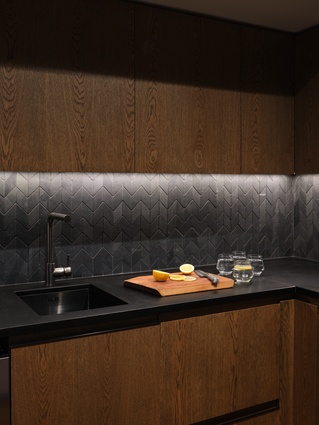 A moody aesthetic is created in the kitchen at Lake Rotoiti.
