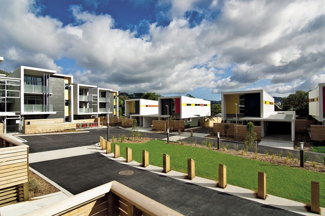 Two-bedroomed apartments are to the left and four-bedroomed houses are on the right. The central landscaped area also provides a play-space for younger residents.