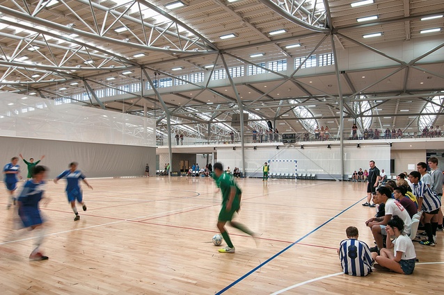 Natural light streams through the bow trusses into the sports hall. The colourful sports teams and equipment are only a distraction within a subtle colour scheme.