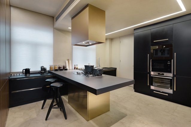 The kitchen and bedroom combine bronze and wood to create a muted, contemporary and traditionally luxe look. 