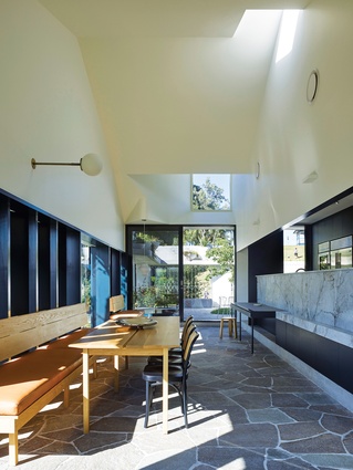 The dining room embraces a connection to the park, while solid timber shutters afford privacy from the street.