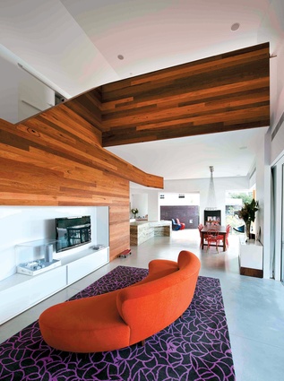 Timber panelling adds warmth to the lofty living spaces. 
