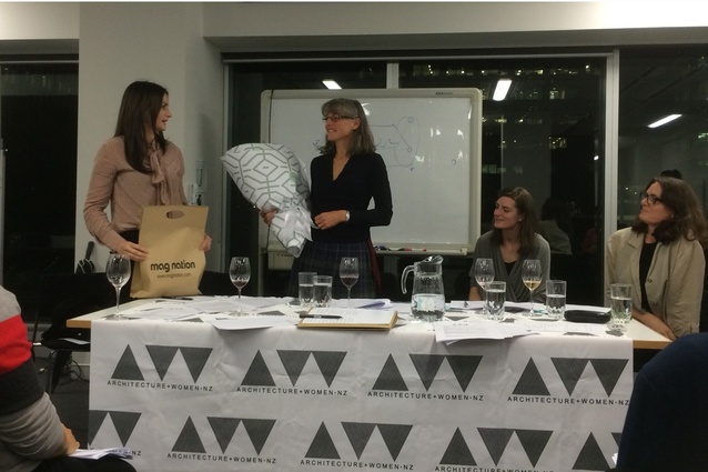 Julie Wilson gifts leaving flowers and present to Megan Rule on behalf of A+W•NZ at the AGM on 26 May.