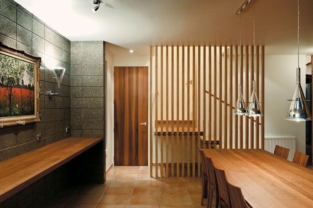 Honed concrete blocks and timber slats give texture to the dining room.