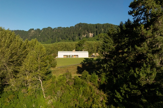 A context view of the holiday home, elevated above the lake on Waipamu Station.