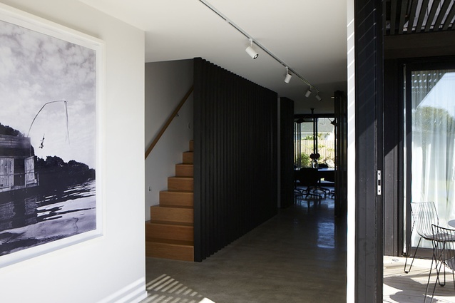 A pivoting glass door separates the rear of the home from the media room and children's rooms, creating two distinct areas. 