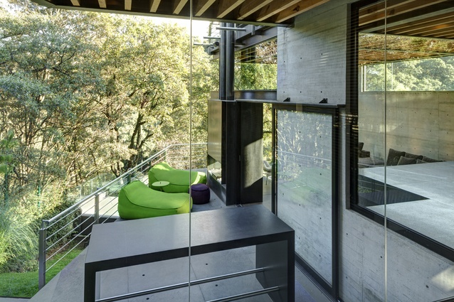 South- and east-facing windows and terraces draw the maximum amount of sunlight into the house while framing the lush garden.