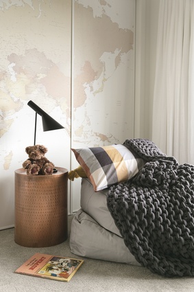 One of the spare bedrooms is designed to appeal to either a child or adult, with a Boston wardrobe hung in Mr Perswall World Map wallpaper from Paper Room. 
