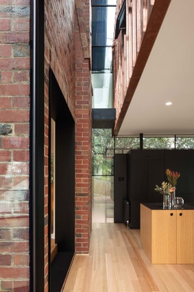A double-height void marks the transition from restored 1930s house to new extension.