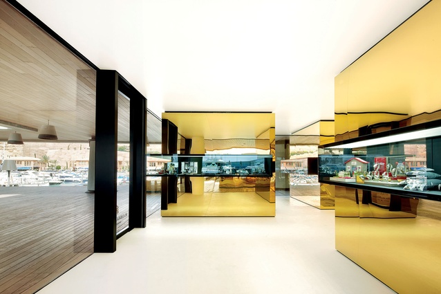 Five ‘precious boxes’ are clad with gold-tinted stainless steel at the Relojeria Alemana jewellery store in Majorca, Spain.