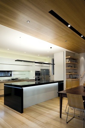 The neutral colour palette of the kitchen blends seamlessly with the large living space.