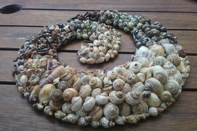 A completed piece of biophilic artwork made from collected sea shells.