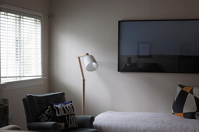 An Angle lamp designed by Snelling sits in a corner of the living room.
